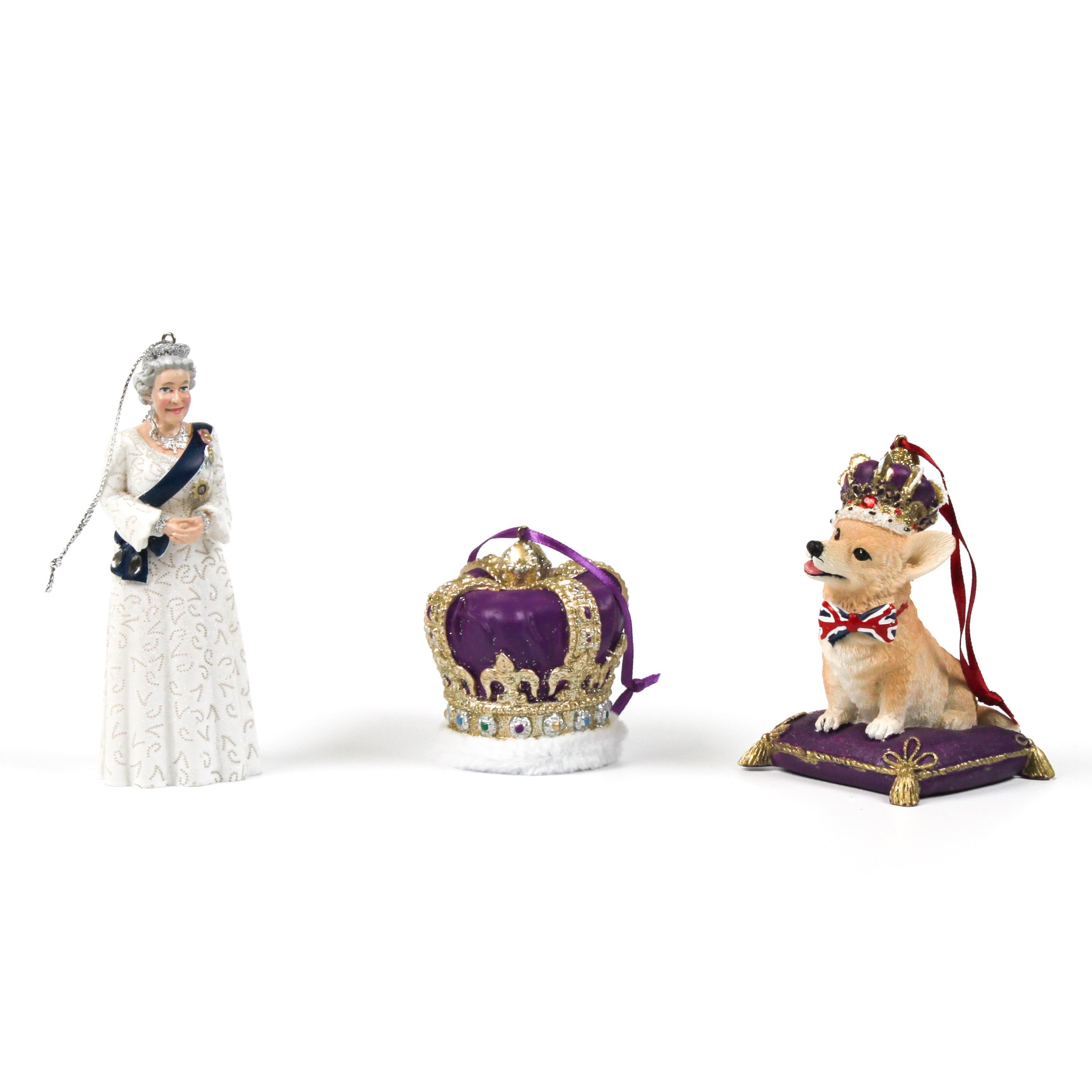 an queen elizabeth ornament, a purple crown ornament and a corgi ornament photographed on a white background.
