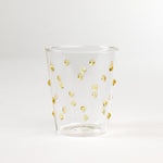 three-dimensional drinking glasses with yellow colored raised dots