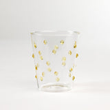 three-dimensional drinking glasses with yellow colored raised dots
