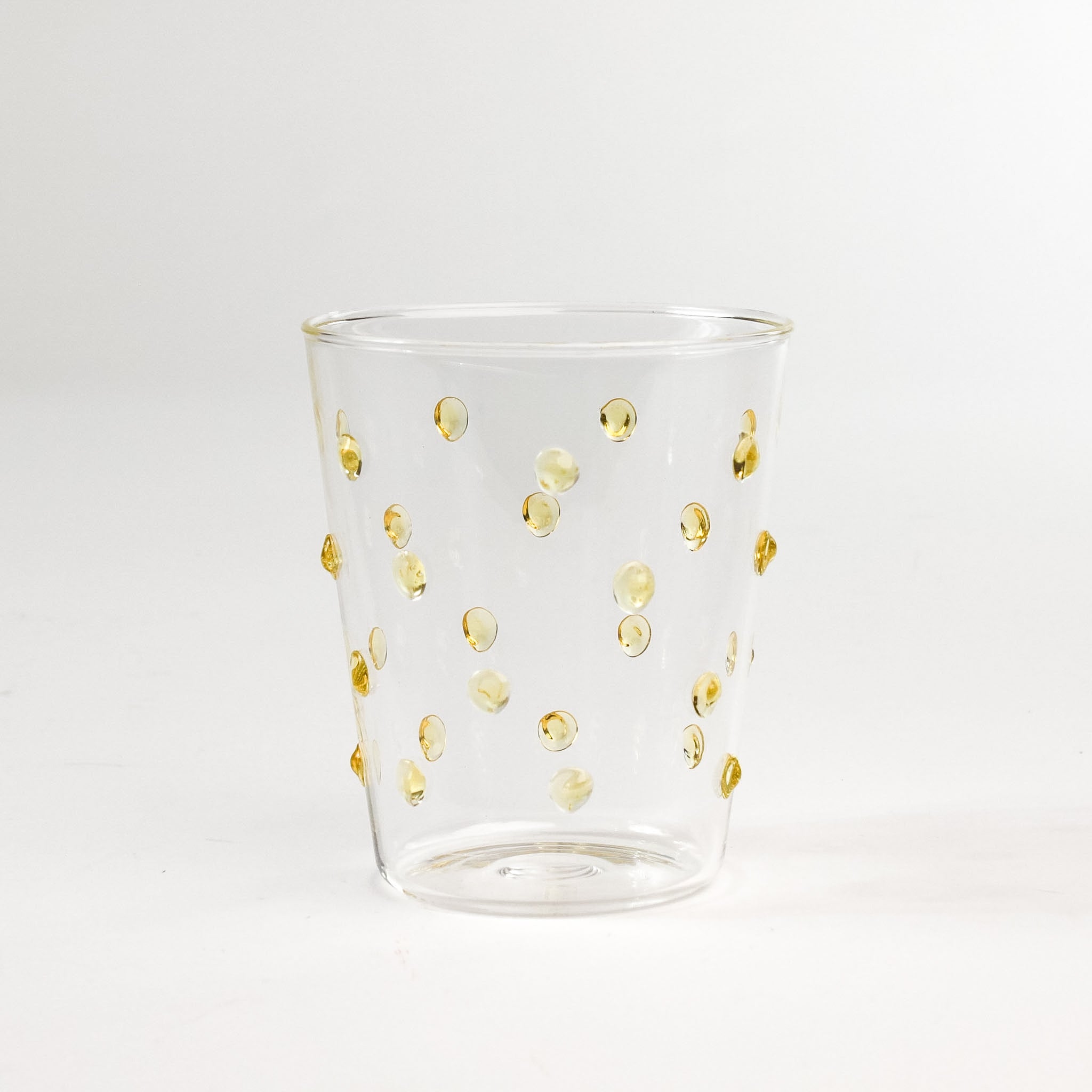 three-dimensional drinking glasses with yellow colored raised dots