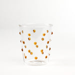 three-dimensional drinking glasses with orange colored raised dots