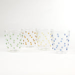 three-dimensional drinking glasses with colored raised dots on a white background