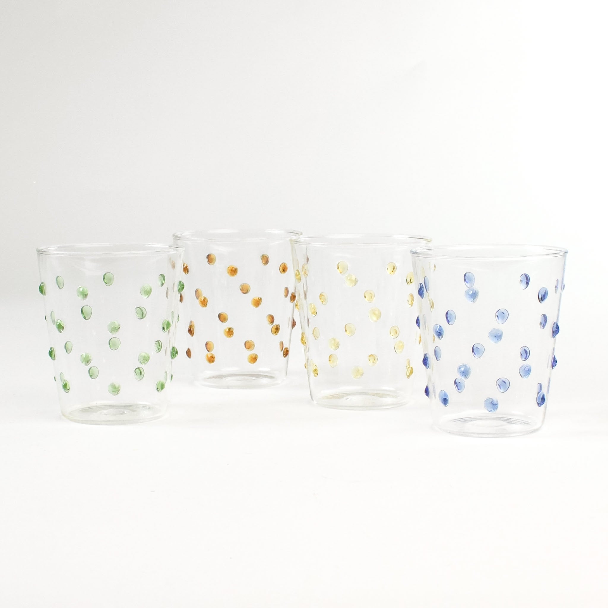 three-dimensional drinking glasses with colored raised dots on a white background