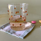 three-dimensional drinking glasses with orange colored raised dots