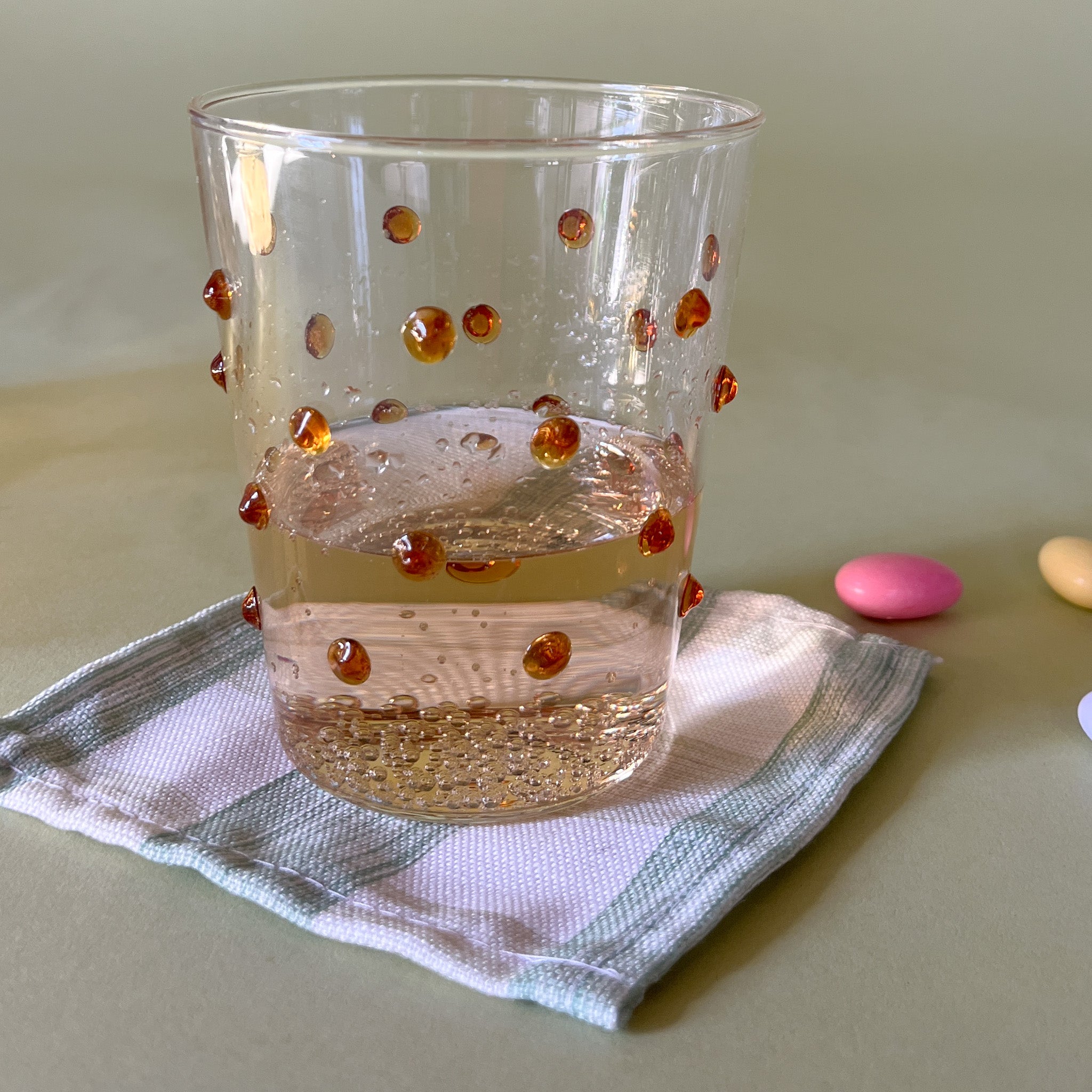 three-dimensional drinking glasses with orange colored raised dots