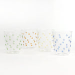 three-dimensional drinking glasses with colored raised dots on white background