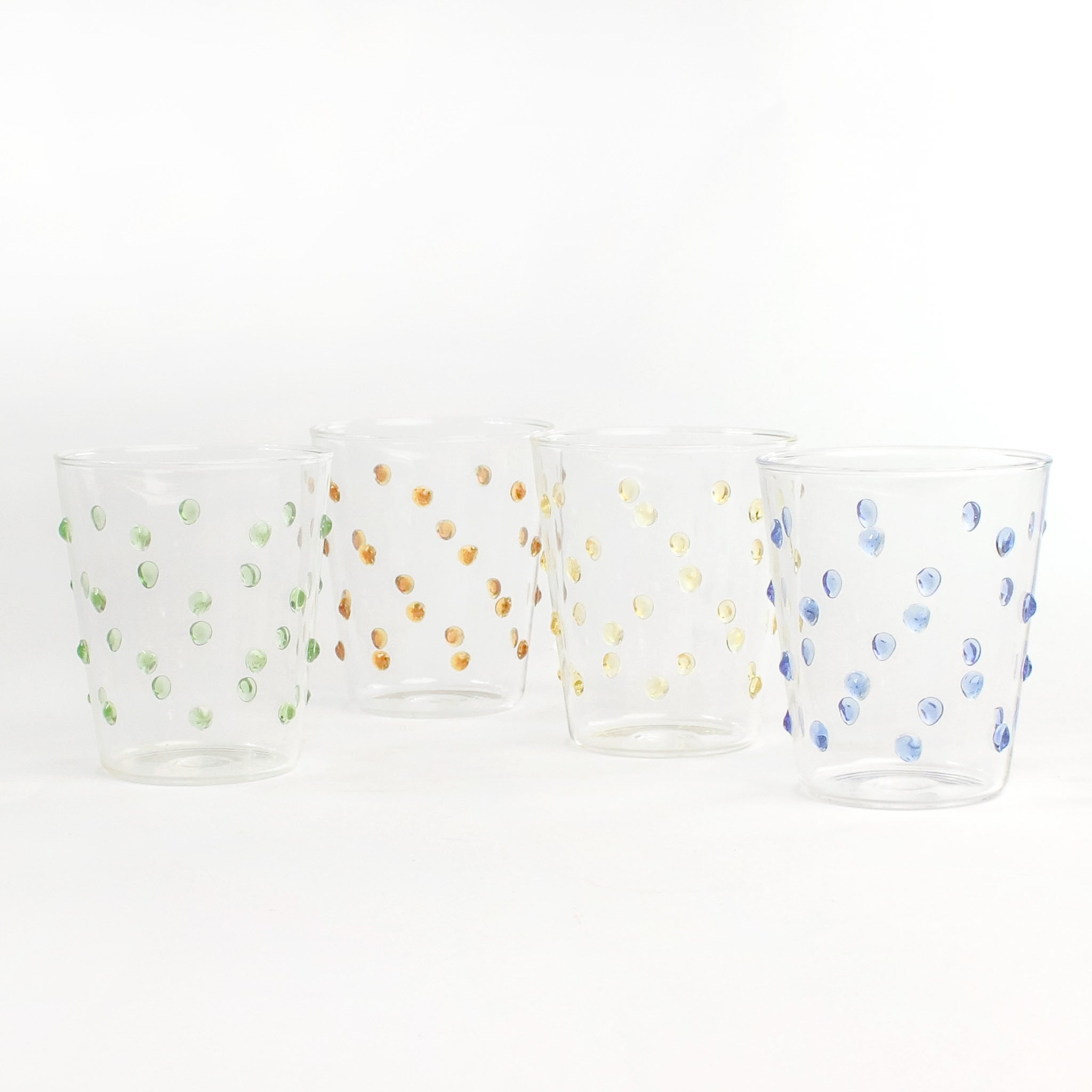 three-dimensional drinking glasses with colored raised dots on white background