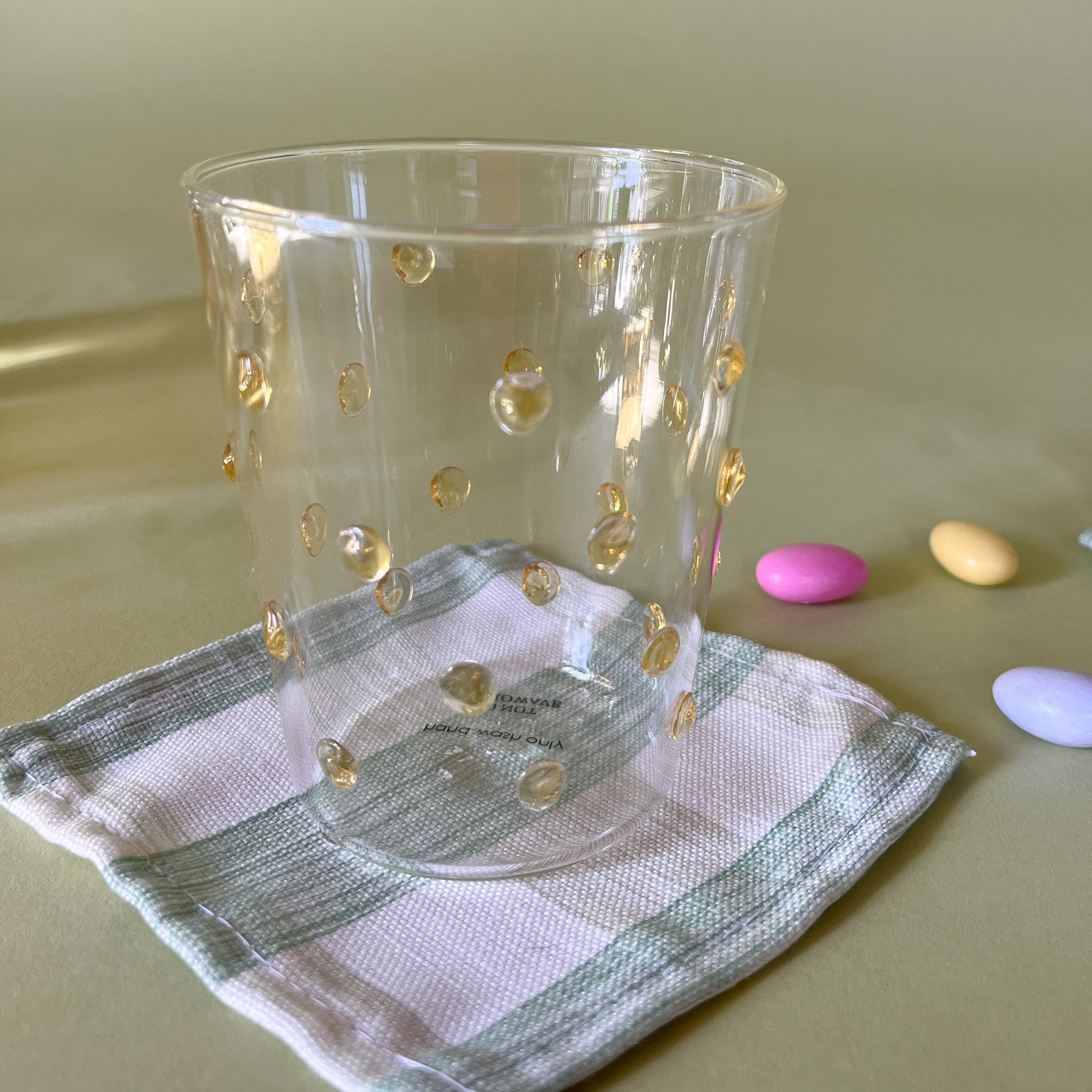 three-dimensional drinking glasses with yellow colored raised dots