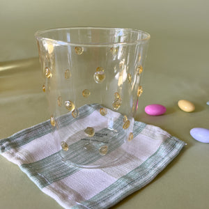 three-dimensional drinking glasses with yellow colored raised dots