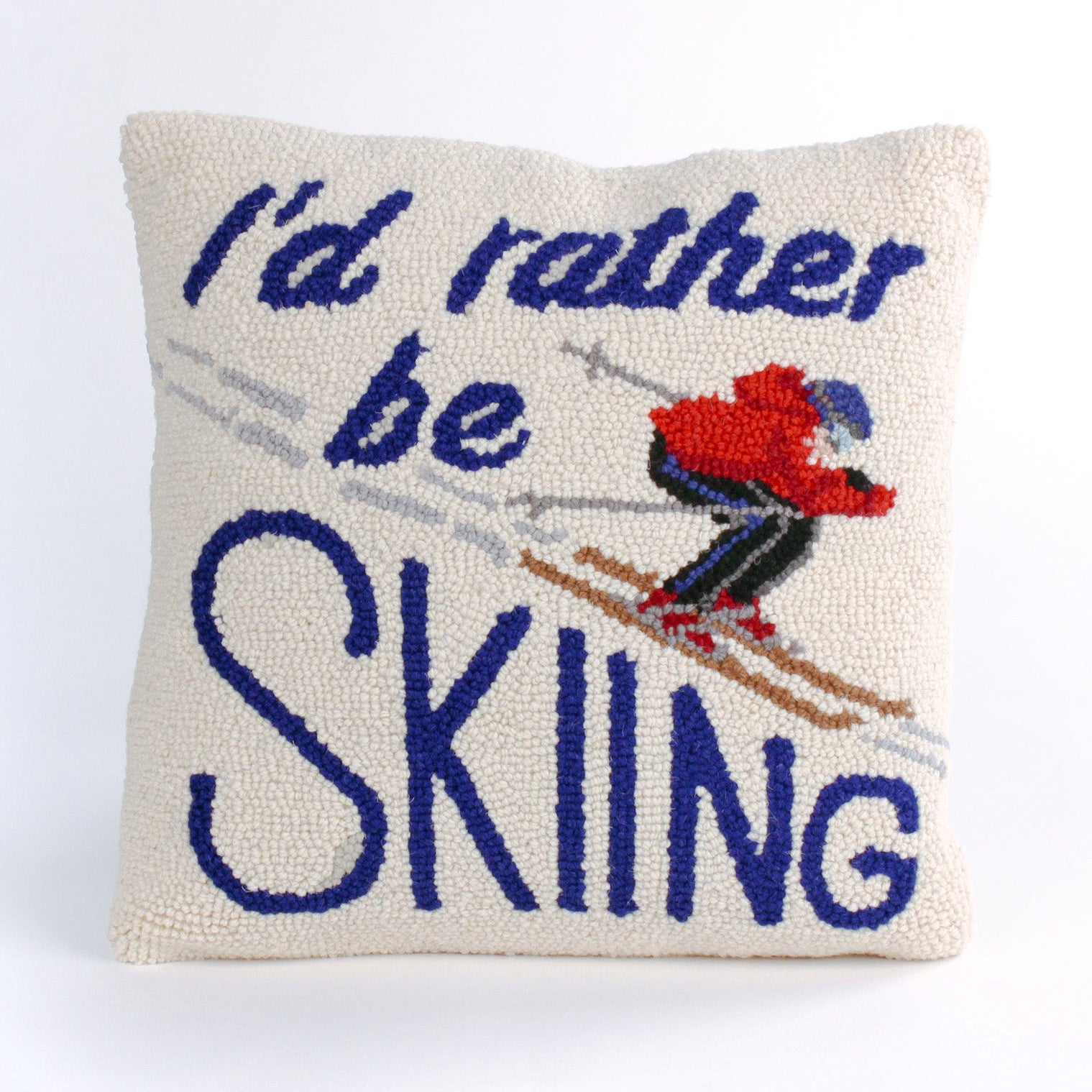 Square decorative pillow with a skier in a red jacket and blue helmet on snowy slopes, featuring the phrase “I’d rather be SKIING” in bold blue text.