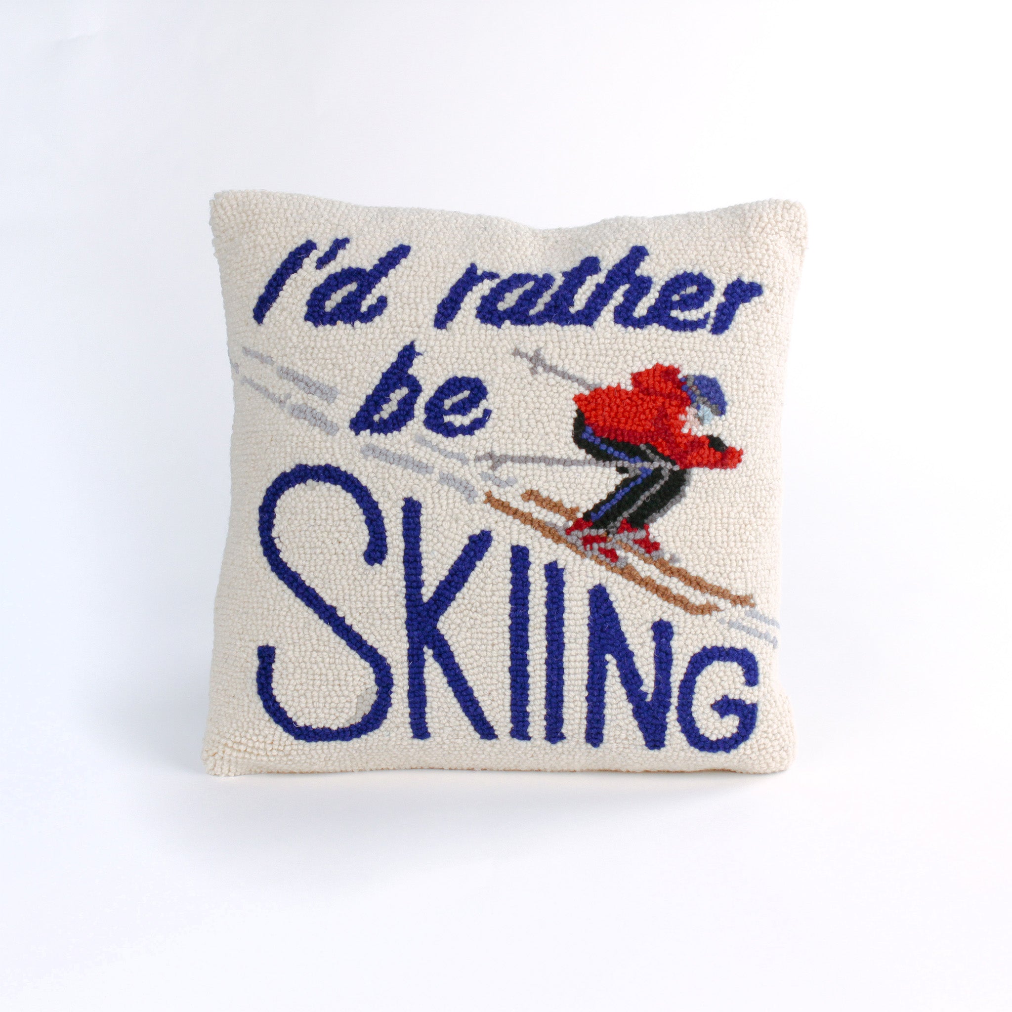 Square decorative pillow with a skier in a red jacket and blue helmet on snowy slopes, featuring the phrase “I’d rather be SKIING” in bold blue text.