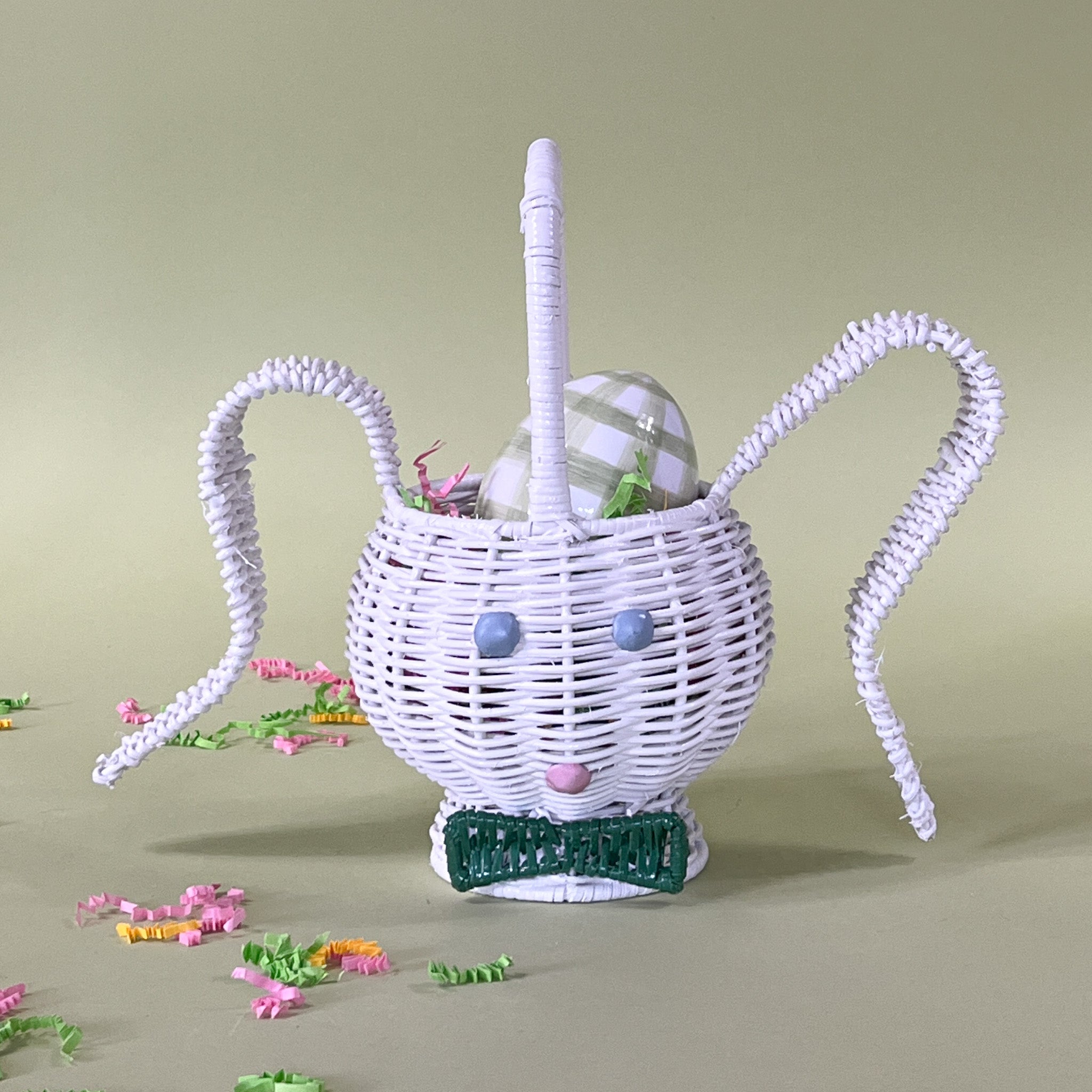 white rattan bunny easter basket with egg in it