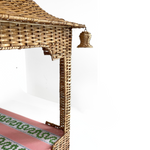 a rattan pagoda dog bed with a green pink and white striped mattress from madcap cottage