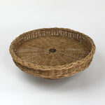 A brown rattan pedestal bowl from madcap cottage