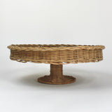 A brown rattan pedestal bowl from madcap cottage