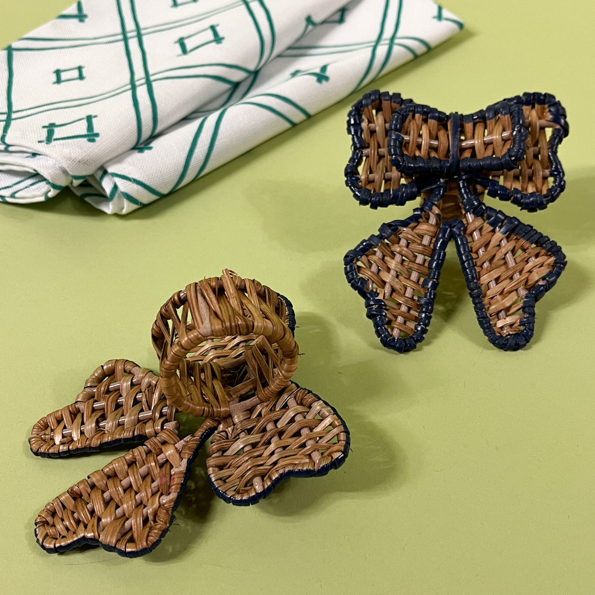 two rattan bow napkin rings with one showing the back side ring detail