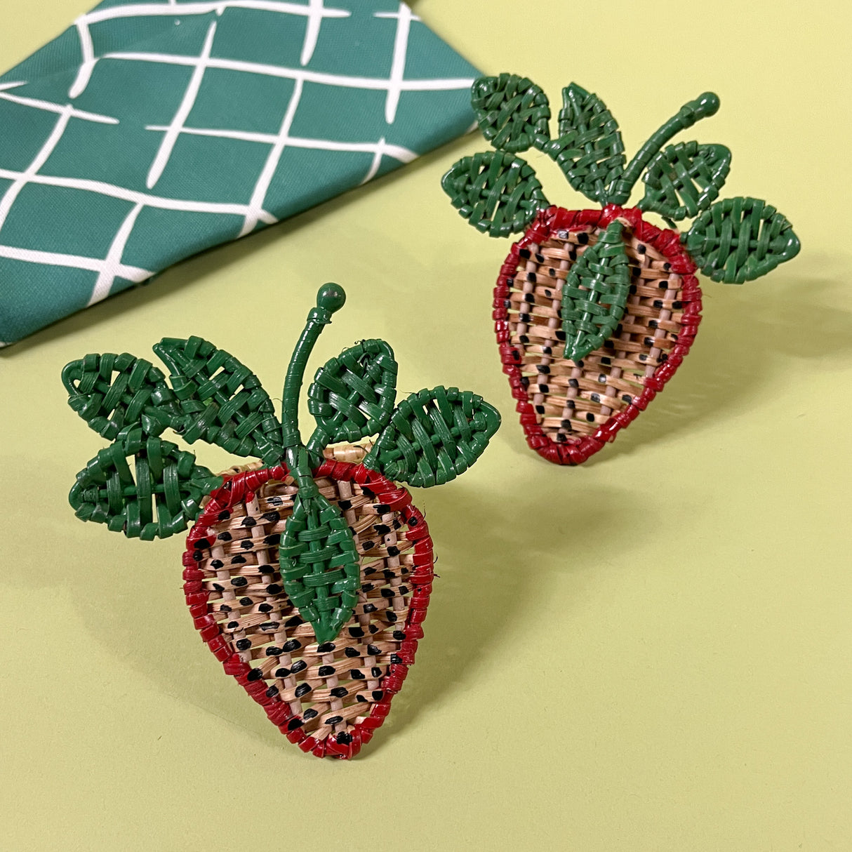 pair rattan strawberry napkin rings with green dinner napkin