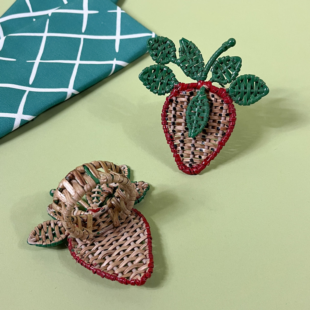 rattan strawberry napkin rings showing reverse ring detail on one with a dinner napkin