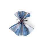 Red Starburst patriotic napkin ring displayed on a blue striped cloth napkin.