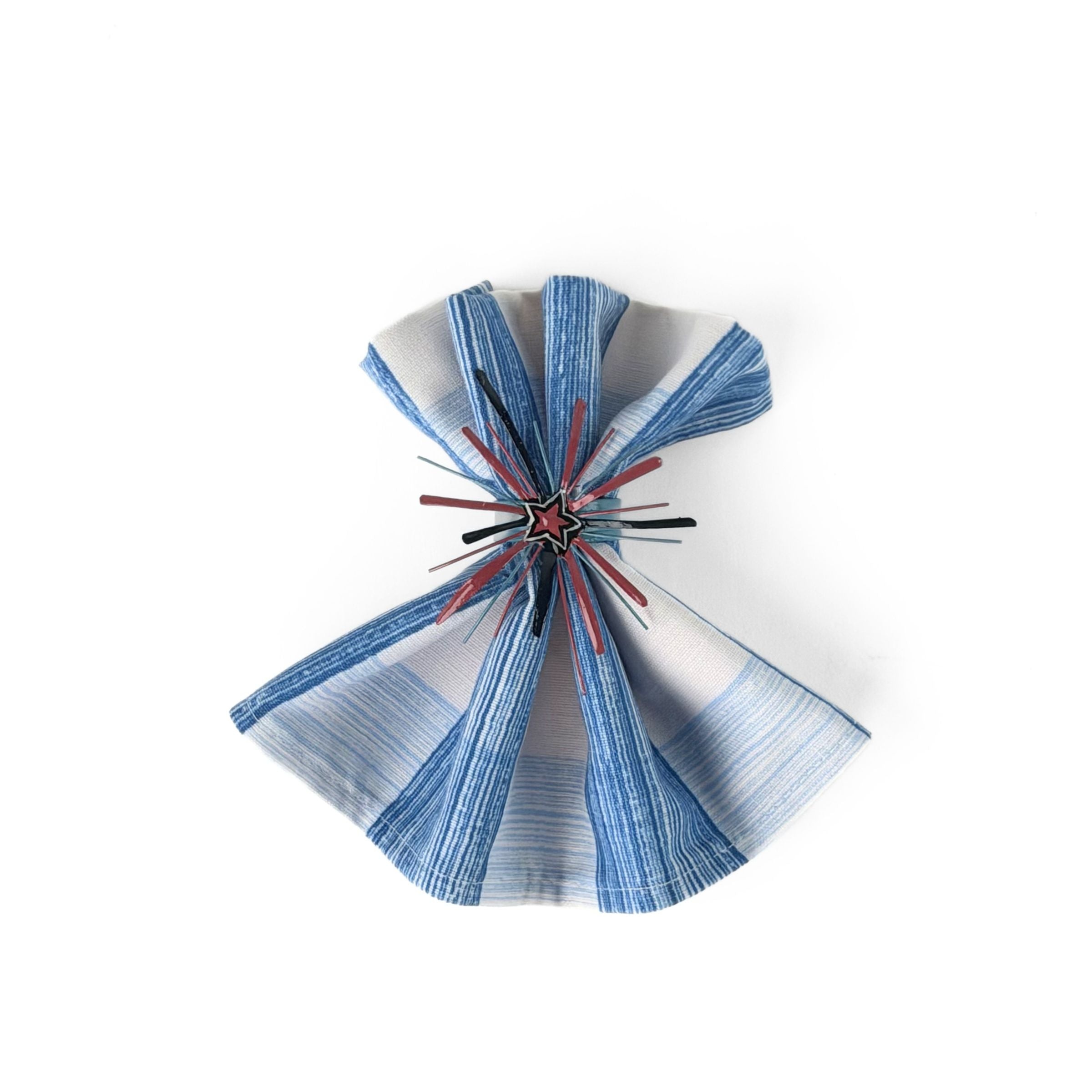 Red Starburst patriotic napkin ring displayed on a blue striped cloth napkin.
