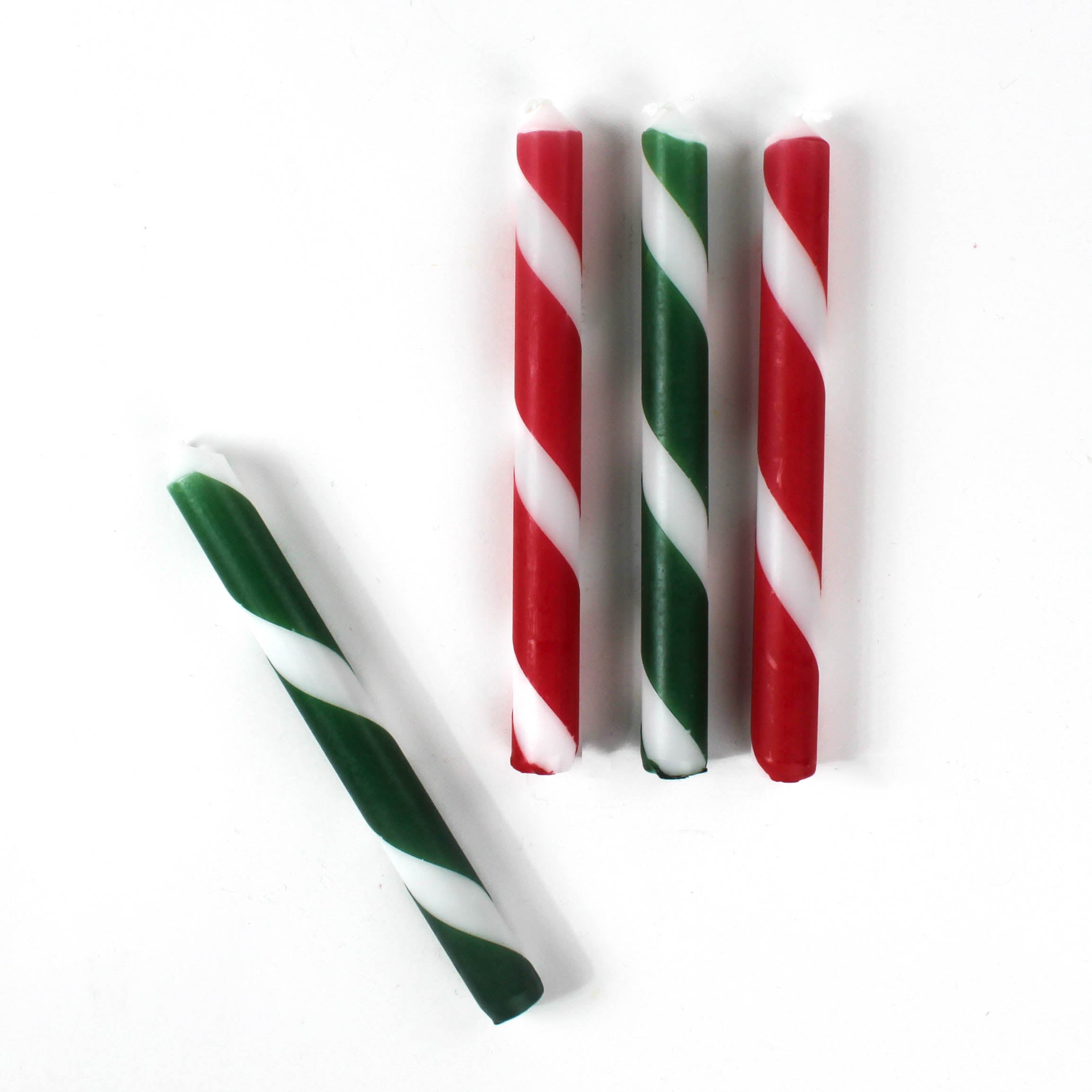 Set of red, green, and white striped christmas taper candles on a white background