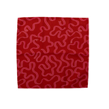 Pin ribbons patterned on a deep red cloth dinner napkin shown open on a white background