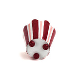 Bottom view of striped tole cachepot with rounded feet and scalloped edge.