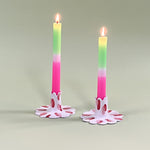 Pair of madcap cottage ceramic candle holders with scalloped edges and a red and Club House pattern holding taper candles.