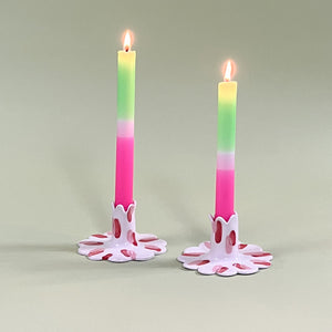 Pair of madcap cottage ceramic candle holders with scalloped edges and a red and Club House pattern holding taper candles.