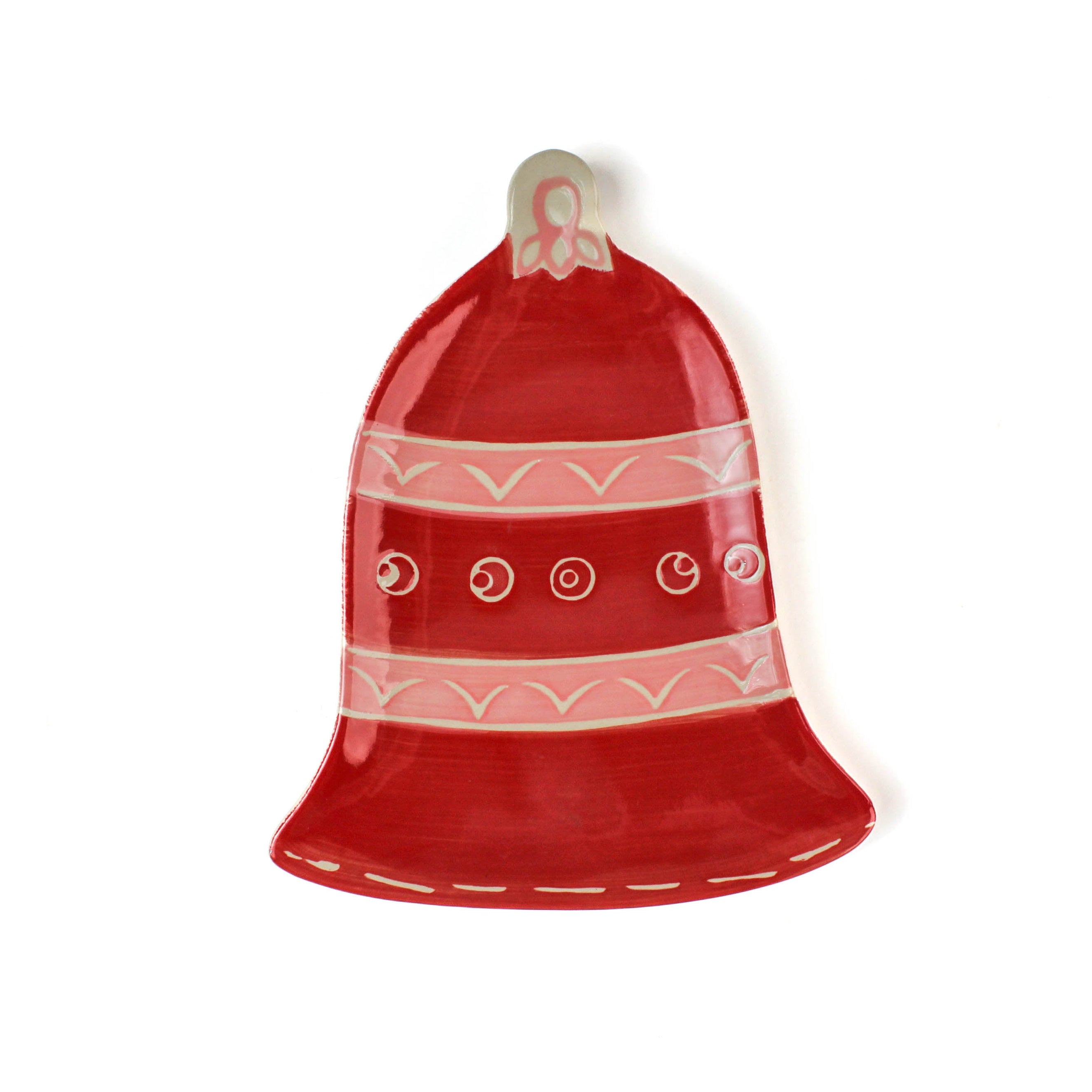 Red bell-shaped christmas dish with white patterns on a white background