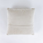 back of a Hooked wool Christmas pillow featuring a square white design with a large red Christmas bow wrapped in multicolored holiday string lights.