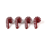 four rattan red and white candy candy christmas napkin rings on a white background. 
