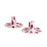 Pair of red and white ceramic petal-shaped candle holders with hand-painted red accents, designed for decorative tabletop display.