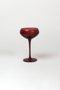 a red coupe glass from madcap cottage o a white background
