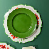 a metal geranium charger plate with a green plate resting on top