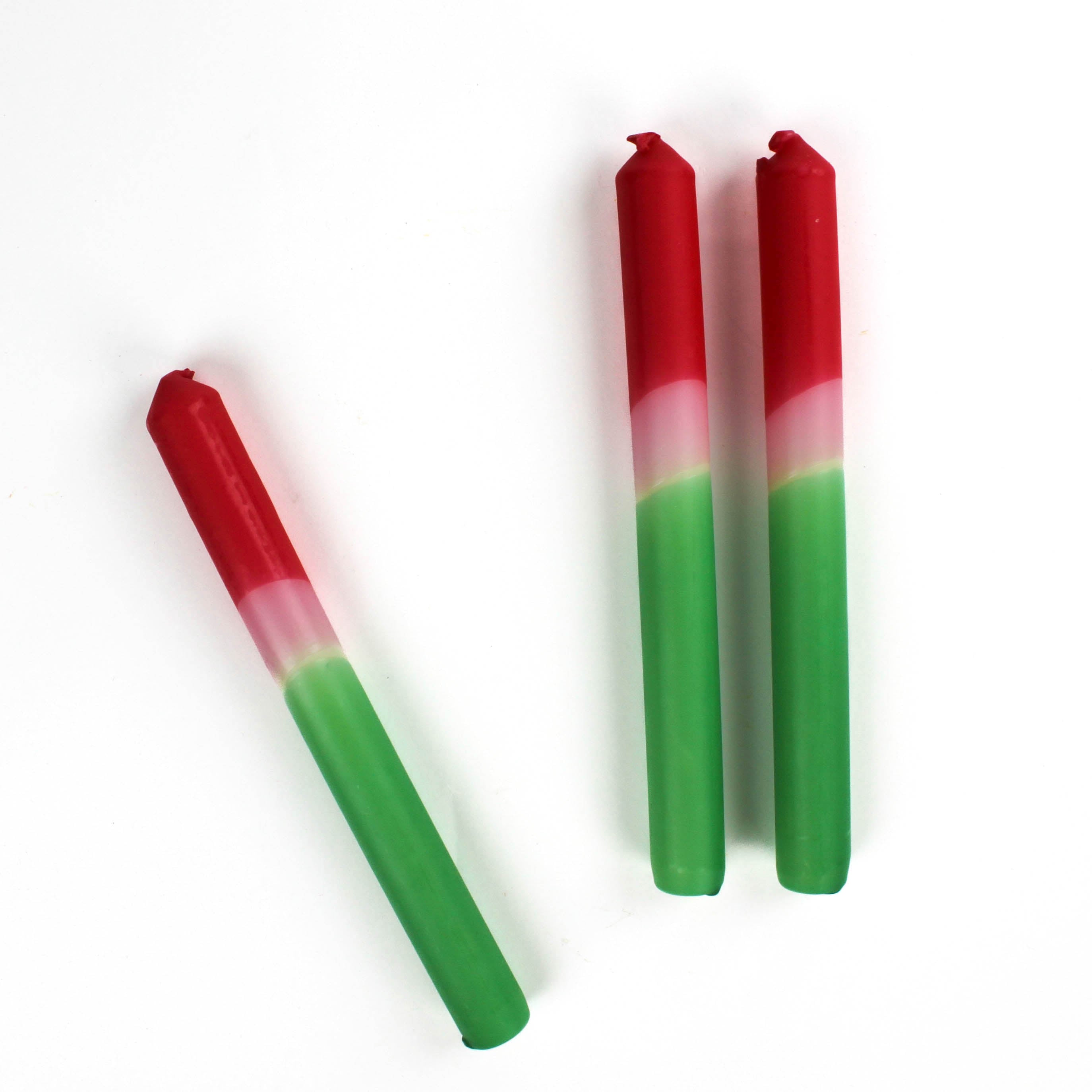 3 Red Pink Taper Candles lying in a white background