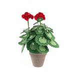 Artificial red geranium plant in a brown pot with layered green leaves, displayed on a white background