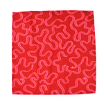 Red napkin cloth with playful pink squiggle pattern on a white background, modern kitchen linen perfect for Christmas tea towel styling, holiday cooking, and seasonal home décor