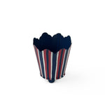 A scalloped top, red white and blue striped cachepot on a white background