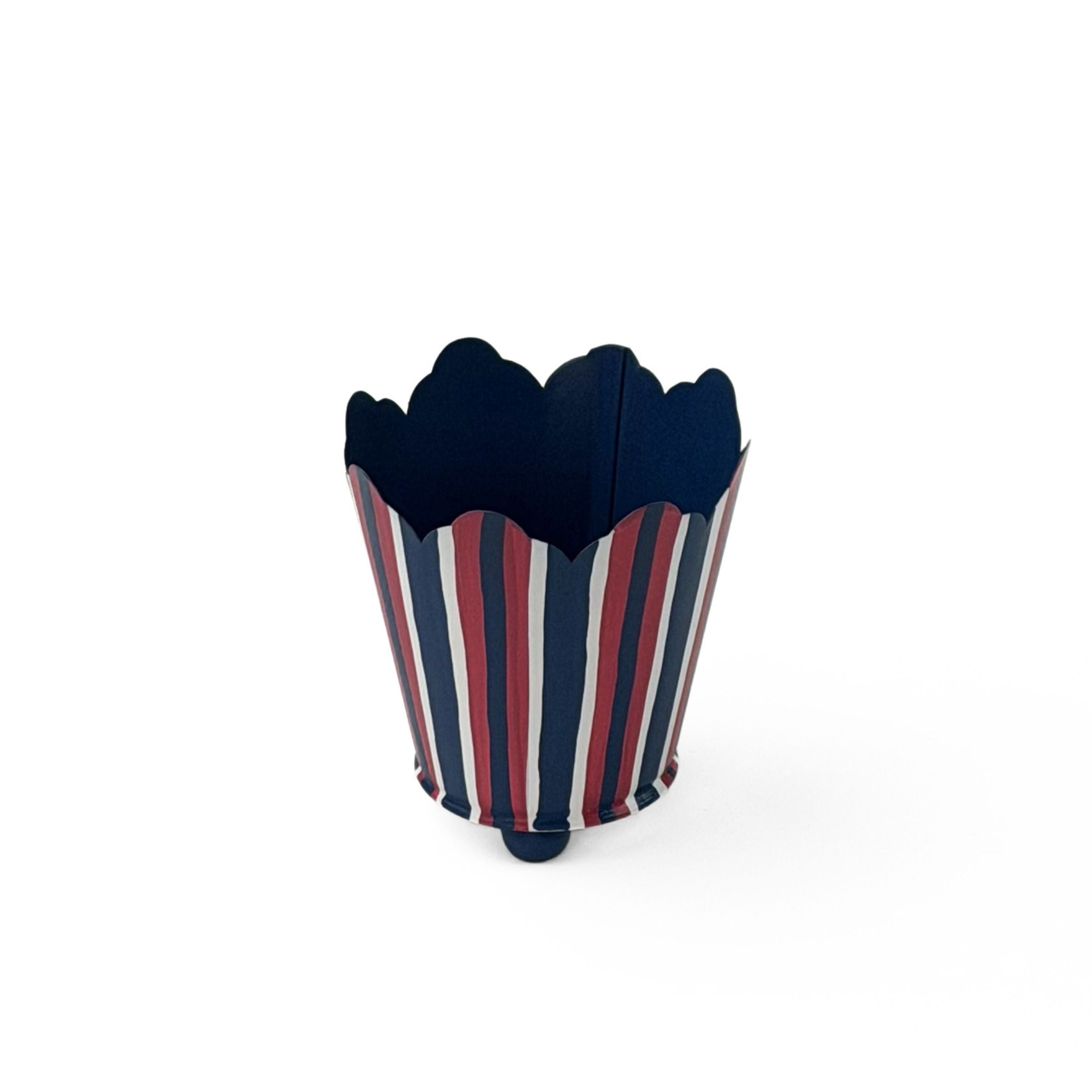 A scalloped top, red white and blue striped cachepot on a white background