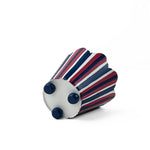 A bottom of a  scalloped top, red white and blue striped cachepot on a white background