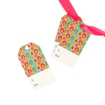 aRetro Trees Christmas gift tags featuring colorful geometric tree patterns in pink, green, blue, and red, a blank reverse side, pre-punched holes.
