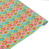 Colorful Christmas gift wrap roll featuring playful retro trees in vibrant pink, green, and blue.