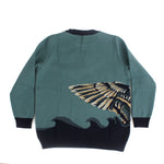 Back view of teal knit sweater featuring a mallard duck wing detail wrapping across the side