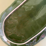 the reverse side of a green ceramic cabbage serving platter