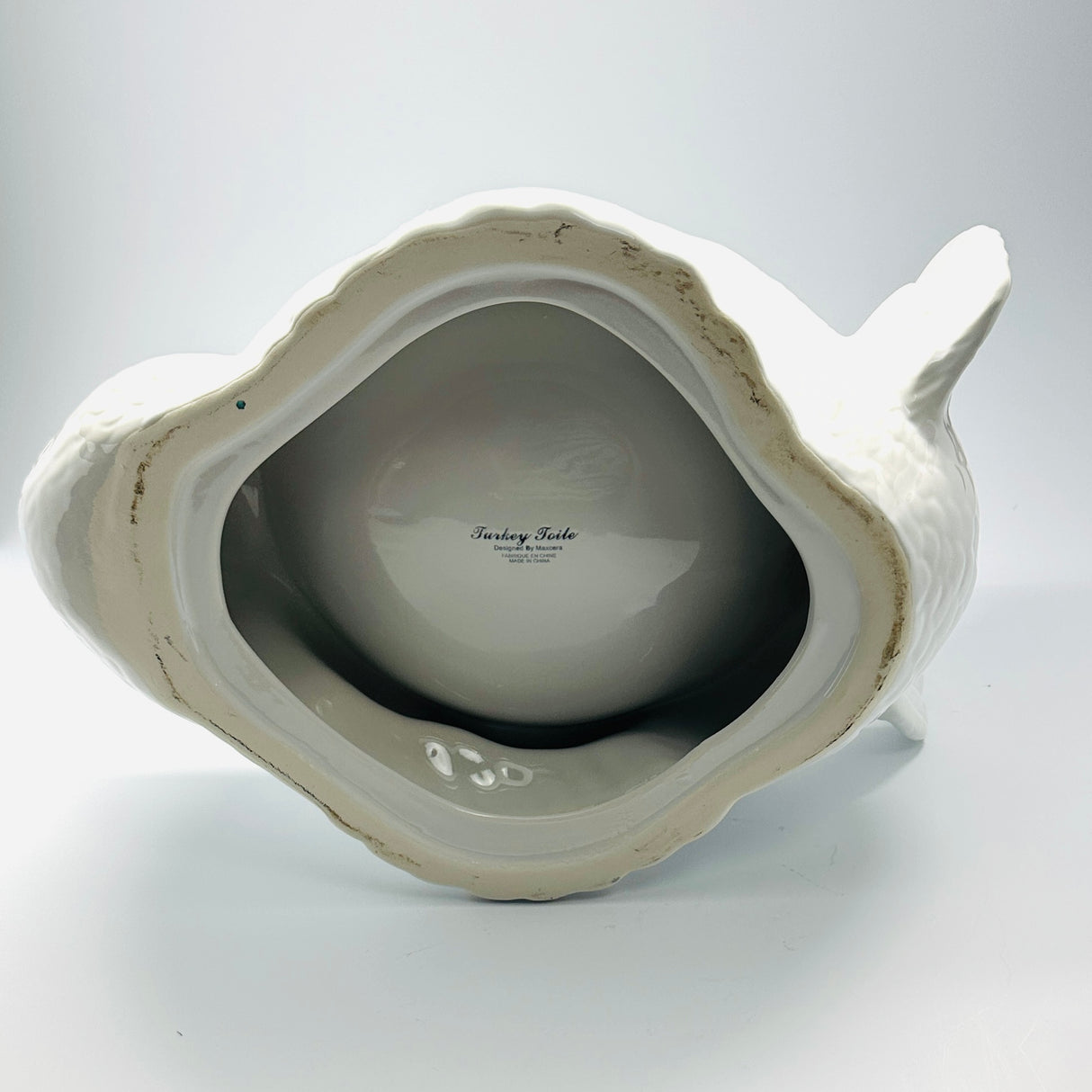 the underside of a white ceramic turkey centerpiece