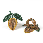  lemon rattan napkin rings in the shape of a lemon with two green leaves against a white background