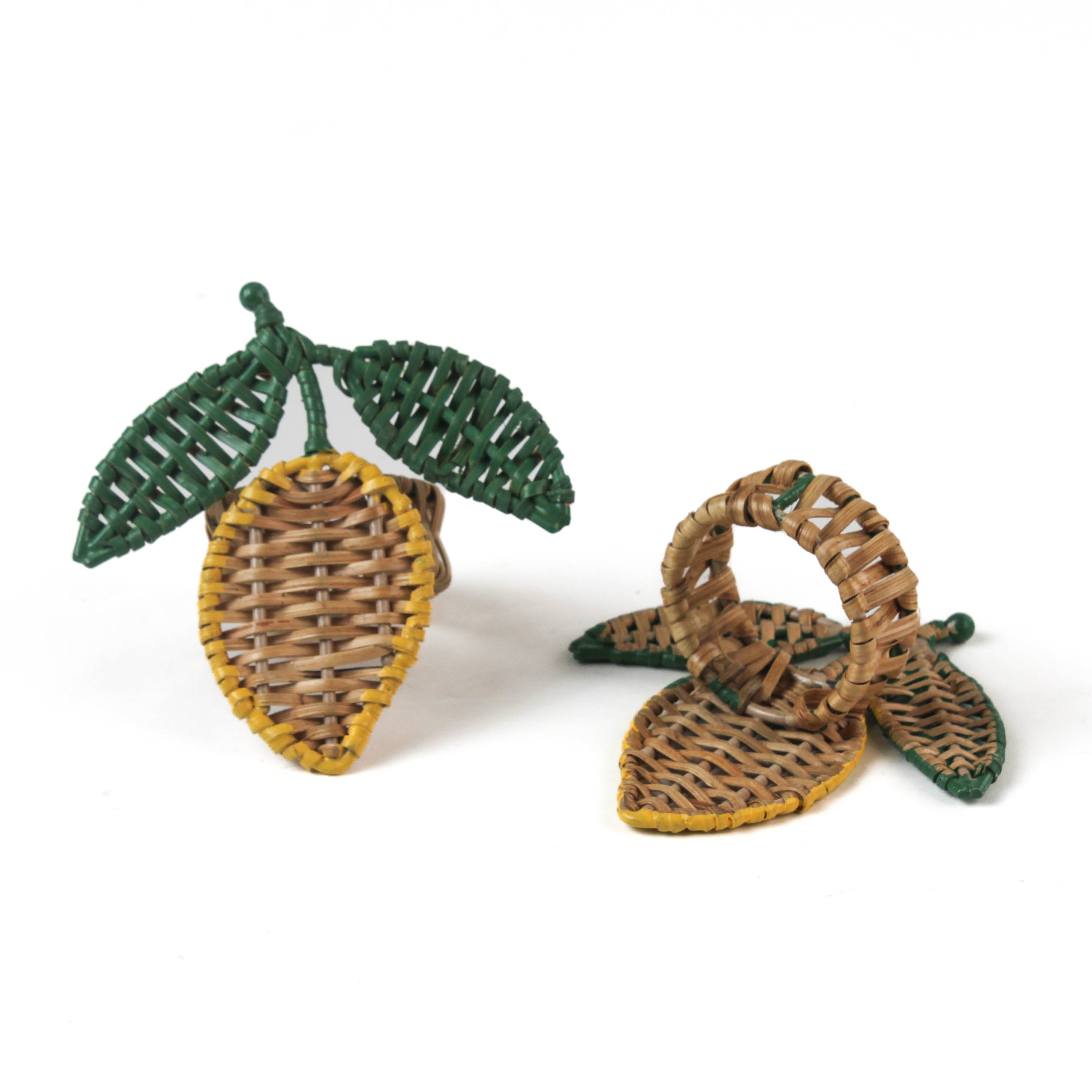  lemon rattan napkin rings in the shape of a lemon with two green leaves against a white background