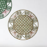 reverse of a Pink/Green Hand-woven Round Rattan Placemats in a white background