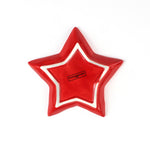 Red star-shaped dish with a white rim on a white background